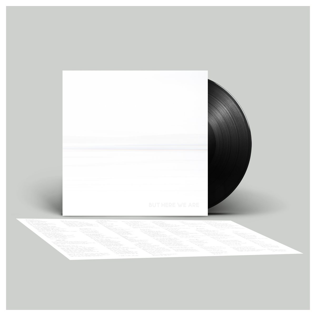 Vinyl record with a white sleeve on a gray background
