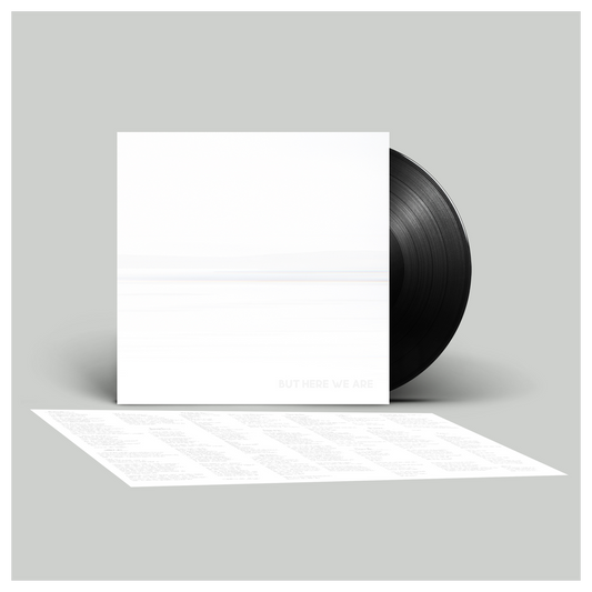 Vinyl record with a white sleeve on a gray background